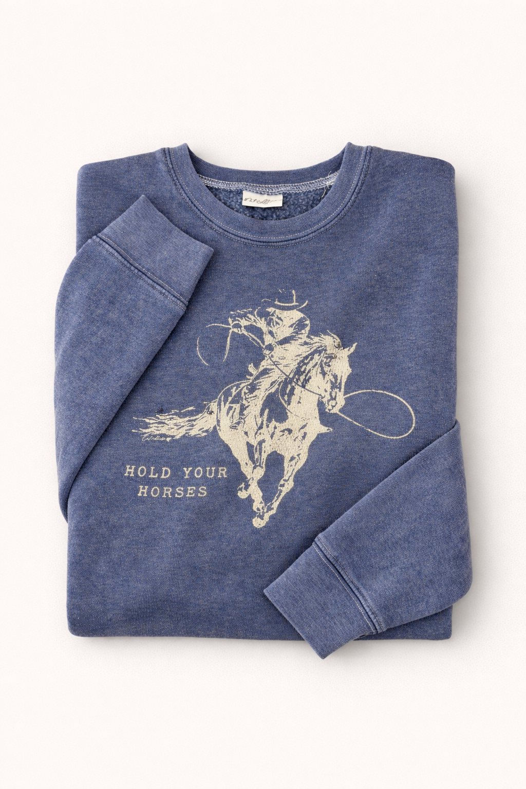 Folded blue sweatshirt with horse graphic and text on a white background