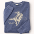 Folded blue sweatshirt with horse graphic and text on a white background