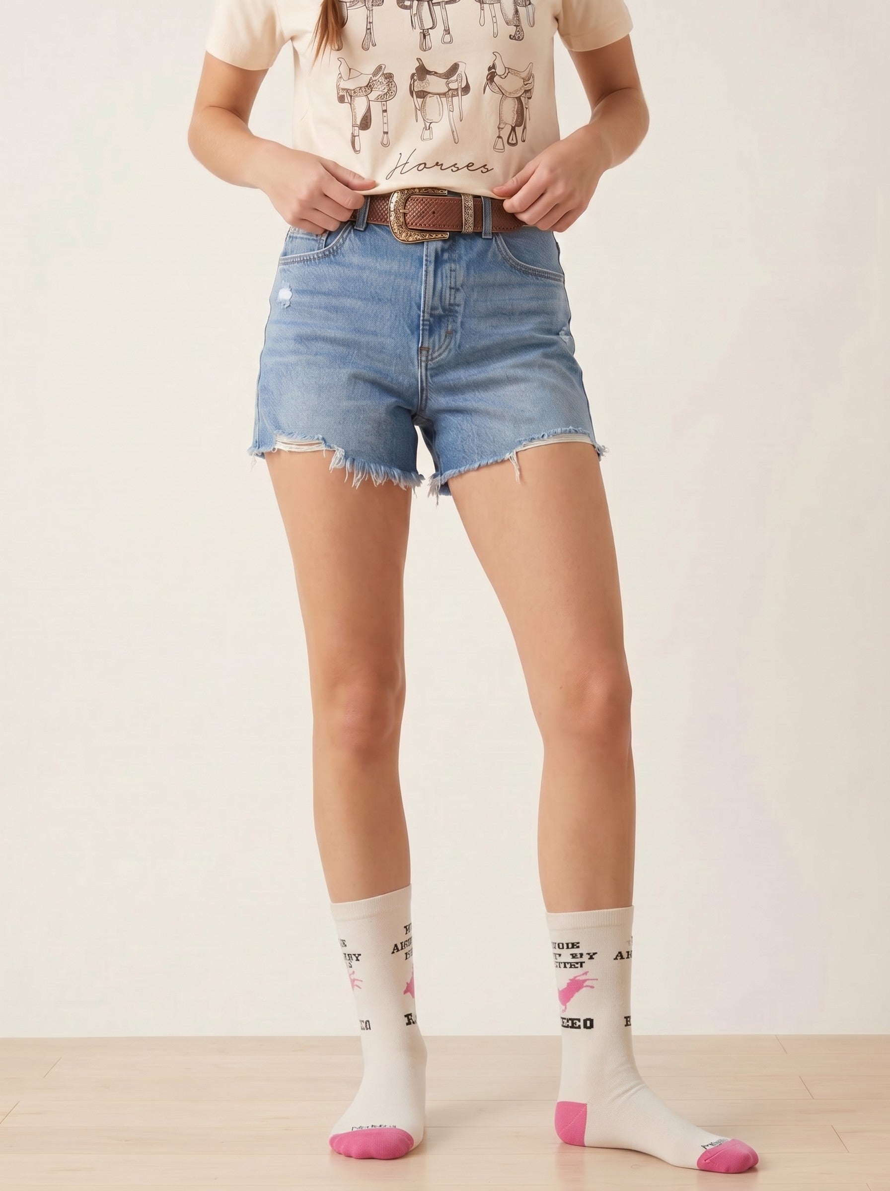 Bridle Up Hope Shop Ain't My First Rodeo crew socks in marshmallow bamboo blend with pink accents on a model