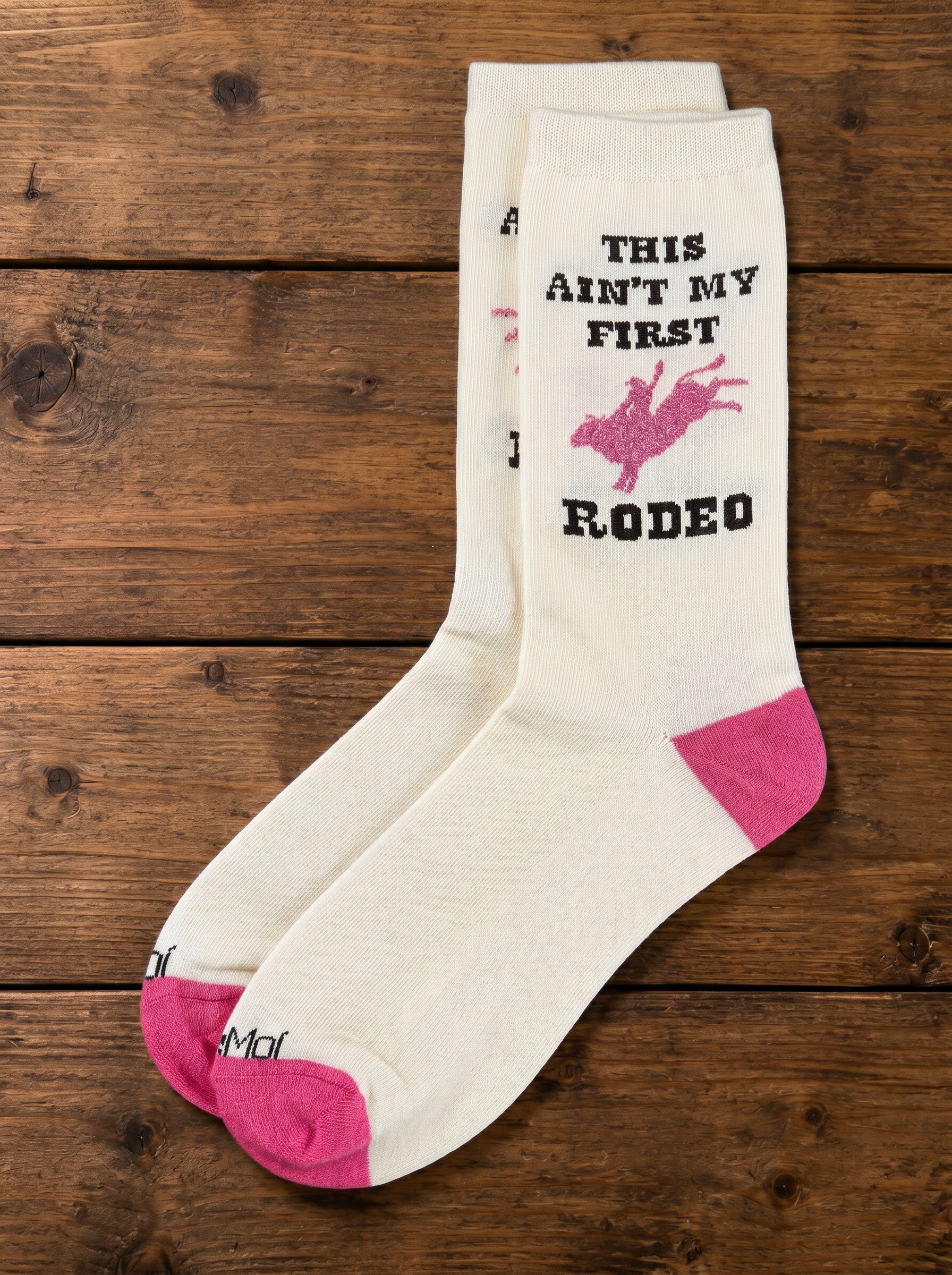 Bridle Up Hope Shop marshmallow crew socks with pink rodeo graphic and text on a rustic wooden background